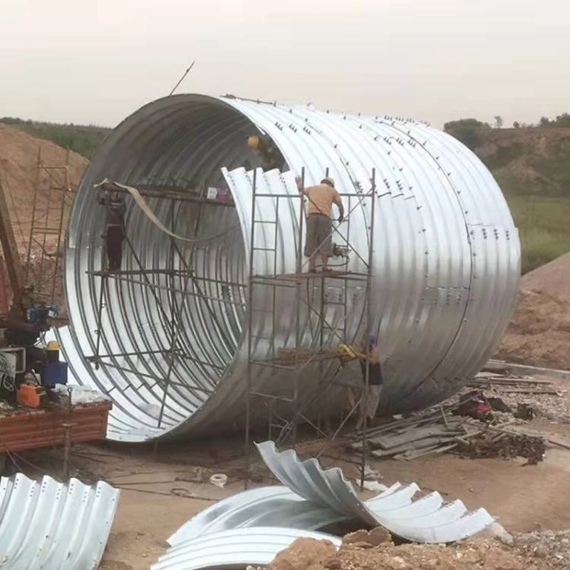 First, the steel plates are carefully inspected upon arrival at the factory. The corrugated steel plates must comply with national regulations, with the waveform and waveform spacing strictly adhering to the design drawings. The length and width are determined based on dimensions, as well as lifting, transportation, and assembly conditions. The corrugated steel pipes, high-strength bolts, and nuts must undergo galvanized anti-corrosion treatment before leaving the factory. Each batch of goods is inspected and accompanied by product certificates. Second, during the transportation and handling of metal corrugated pipe culverts, extra caution must be exercised. Rolling or impacting hard objects is strictly prohibited to prevent deformation of the corrugated pipe walls or damage to the galvanized layer. Third, after arriving at the construction site, the dimensions of each piece must be inspected. A random sample of plates and high-strength bolts from the metal corrugated pipe culvert should be selected for testing, including checks on dimensions, corrosion resistance, strength, and other relevant items. The test results must comply with national requirements. Fourth, after inspection, store the materials in a well-ventilated and spacious area. Protective measures should be taken to prevent the metal corrugated pipes from being soaked by rainwater, which could cause deformation. First, the steel plates are carefully inspected upon arrival at the factory. The corrugated steel plates must comply with national regulations, with the waveform and waveform spacing strictly adhering to the design drawings. The length and width are determined based on dimensions, as well as lifting, transportation, and assembly conditions. The corrugated steel pipes, high-strength bolts, and nuts must undergo galvanized anti-corrosion treatment before leaving the factory. Each batch of goods is inspected and accompanied by product certificates. Second, during the transportation and handling of metal corrugated pipe culverts, extra caution must be exercised. Rolling or impacting hard objects is strictly prohibited to prevent deformation of the corrugated pipe walls or damage to the galvanized layer. Third, after arriving at the construction site, the dimensions of each piece must be inspected. A random sample of plates and high-strength bolts from the metal corrugated pipe culvert should be selected for testing, including checks on dimensions, corrosion resistance, strength, and other relevant items. The test results must comply with national requirements. Fourth, after inspection, store the materials in a well-ventilated and spacious area. Protective measures should be taken to prevent the metal corrugated pipes from being soaked by rainwater, which could cause deformation.