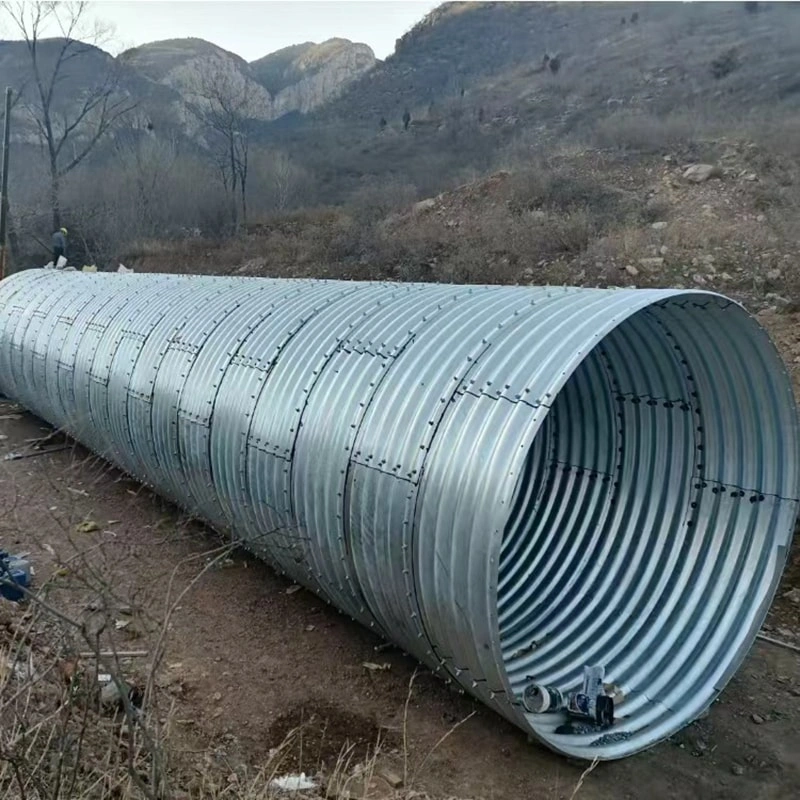 First, the steel plates are carefully inspected upon arrival at the factory. The corrugated steel plates must comply with national regulations, with the waveform and waveform spacing strictly adhering to the design drawings. The length and width are determined based on dimensions, as well as lifting, transportation, and assembly conditions. The corrugated steel pipes, high-strength bolts, and nuts must undergo galvanized anti-corrosion treatment before leaving the factory. Each batch of goods is inspected and accompanied by product certificates. Second, during the transportation and handling of metal corrugated pipe culverts, extra caution must be exercised. Rolling or impacting hard objects is strictly prohibited to prevent deformation of the corrugated pipe walls or damage to the galvanized layer. Third, after arriving at the construction site, the dimensions of each piece must be inspected. A random sample of plates and high-strength bolts from the metal corrugated pipe culvert should be selected for testing, including checks on dimensions, corrosion resistance, strength, and other relevant items. The test results must comply with national requirements. Fourth, after inspection, store the materials in a well-ventilated and spacious area. Protective measures should be taken to prevent the metal corrugated pipes from being soaked by rainwater, which could cause deformation. First, the steel plates are carefully inspected upon arrival at the factory. The corrugated steel plates must comply with national regulations, with the waveform and waveform spacing strictly adhering to the design drawings. The length and width are determined based on dimensions, as well as lifting, transportation, and assembly conditions. The corrugated steel pipes, high-strength bolts, and nuts must undergo galvanized anti-corrosion treatment before leaving the factory. Each batch of goods is inspected and accompanied by product certificates. Second, during the transportation and handling of metal corrugated pipe culverts, extra caution must be exercised. Rolling or impacting hard objects is strictly prohibited to prevent deformation of the corrugated pipe walls or damage to the galvanized layer. Third, after arriving at the construction site, the dimensions of each piece must be inspected. A random sample of plates and high-strength bolts from the metal corrugated pipe culvert should be selected for testing, including checks on dimensions, corrosion resistance, strength, and other relevant items. The test results must comply with national requirements. Fourth, after inspection, store the materials in a well-ventilated and spacious area. Protective measures should be taken to prevent the metal corrugated pipes from being soaked by rainwater, which could cause deformation.